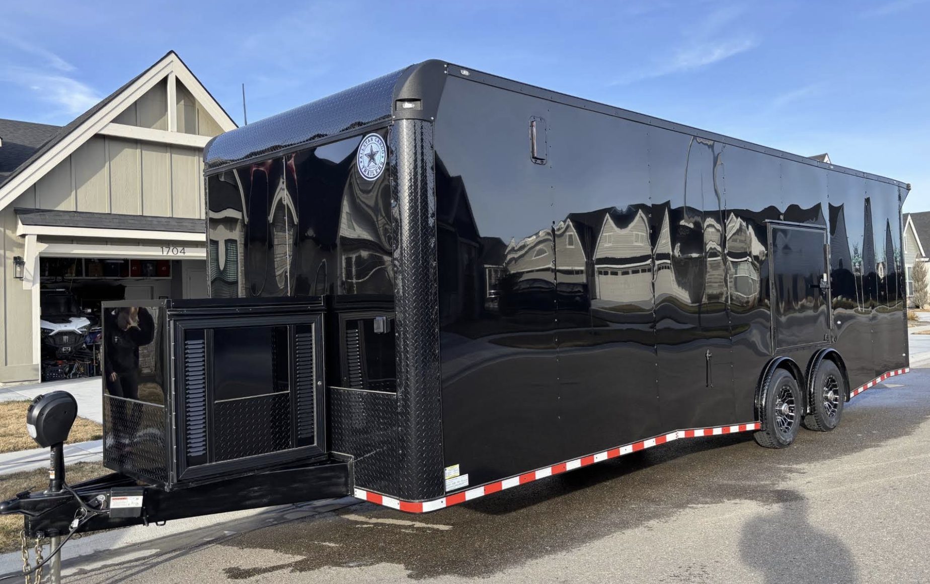 Black enclosed cargo trailer polished to a mirror finish after oxidation restoration